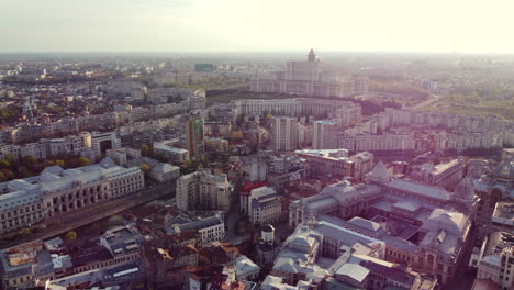 beautiful cinematic aerial, bucharest city centre skyline, lens flare