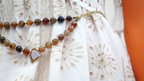 brown and red agate belt on a white dress