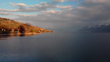 drone's flight over the leman lake from vevey, featuring the ferry boat going to the french border and aiming at the mountains
