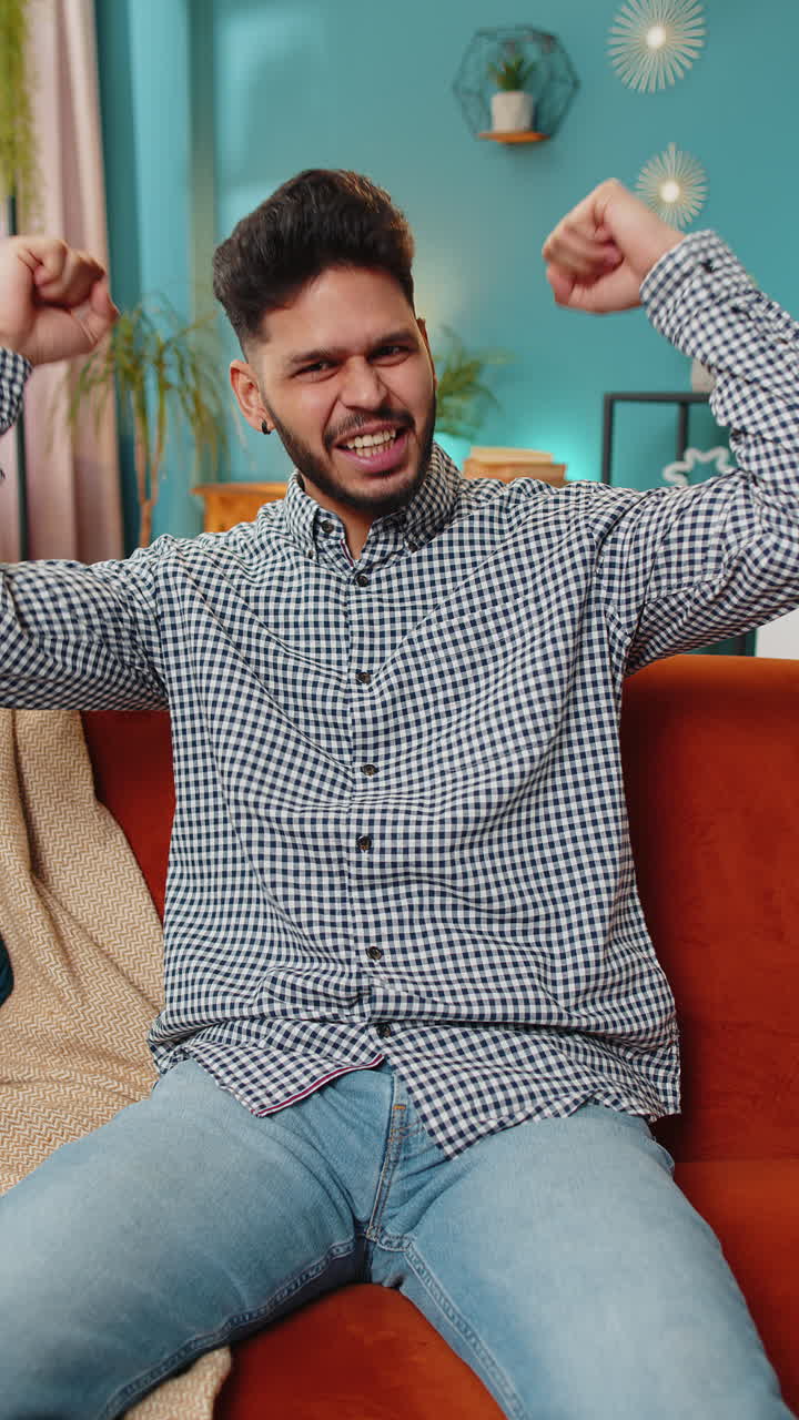 Excited happy indian man surprised shocked by sudden victory good win news celebrate wow reaction