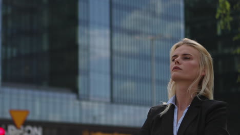 Young-businesswoman-on-the-background-of-office-buildings