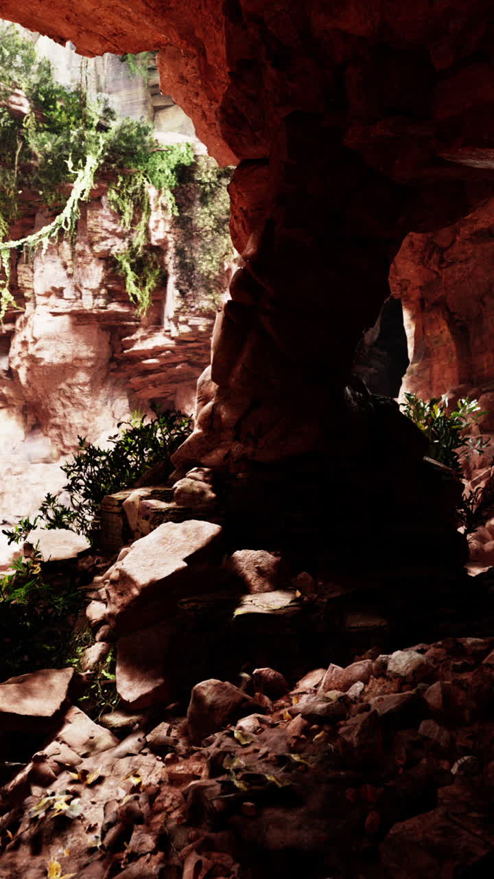 A narrow canyon with red rock walls and a stone arch
