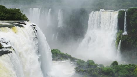 Beautiful-Sunny-Conditions-in-Green-Rainforest,-Amazing-Huge-Waterfalls-Crashing-into-Large-Rocky-Water-Pools,-Bright-Colourful-Views-in-Iguazu-Falls,-Brazil,-South-America