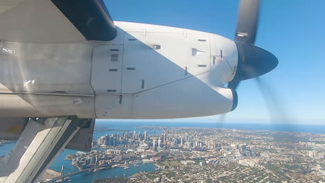 aircraft preparing to land extending landing gear on approach to sydney airport flying over sydney harbour australia