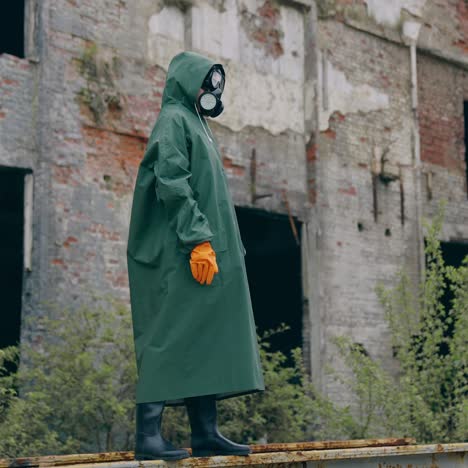 man in protective mask on ruins. dramatic portrait of man wearing gas mask near ruined building