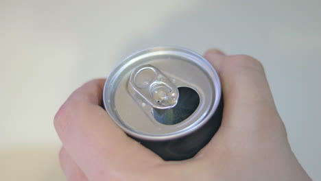 grabbing and opening a soda can