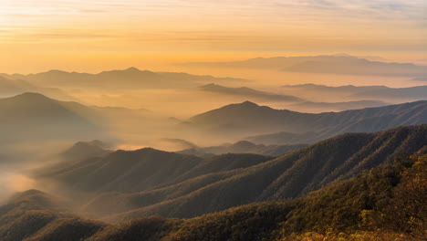 misty mountain range at sunrise or sunset