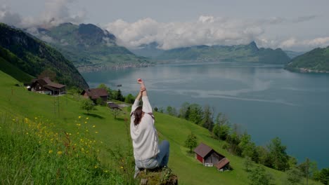 woman relaxing on hillside overlooking lake lucerne