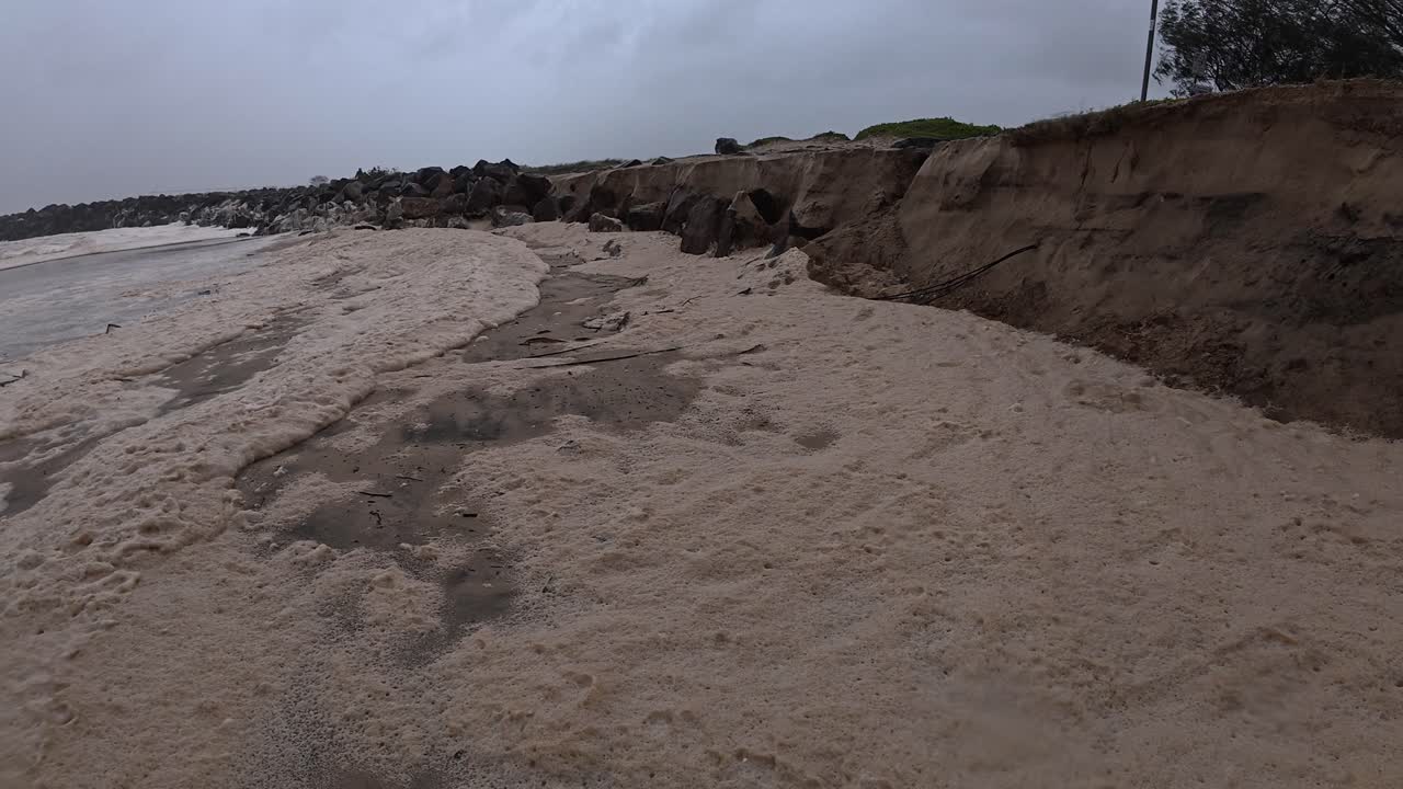 Beach Foam Brought By Waves During Cyclone Alfred At Duranbah Beach, NSW, Australia. static shot