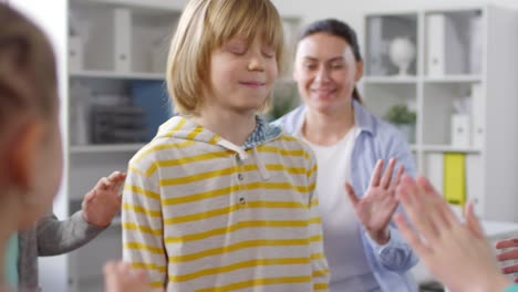 12-year-old blond boy playing psychological game with friends