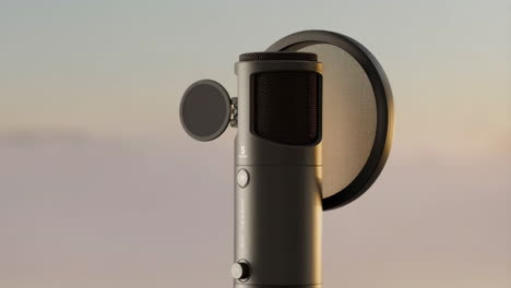 professional condenser microphone with pop filter against a soft sky background