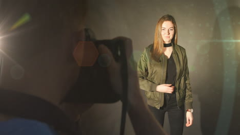 animation of light over caucasian male photographer and female model taking photos