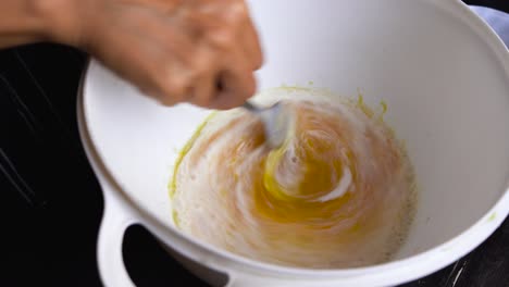 Chef-making-homemade-caramel-sauce,-mixing-cream-into-sugar-and-butter,-closeup