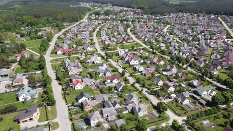 AERIAL-Descending-Flyby-of-the-suburbs-of-a-small-town-Ukmerge-in-Lithuania