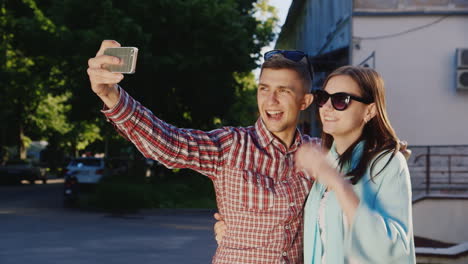 a loving couple makes selfie in the rays of the sun outdoors hd video