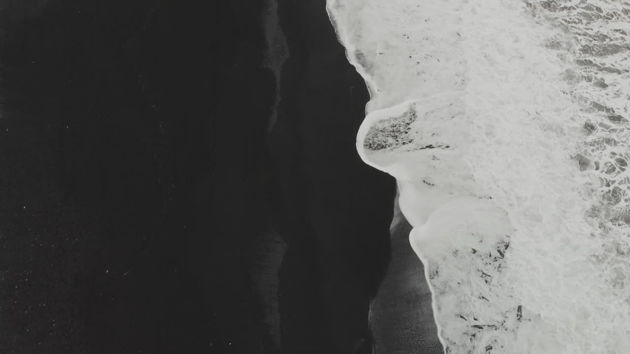 Black Sand Beach with Waves and People
