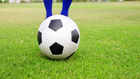 football player kicking a ball in the field