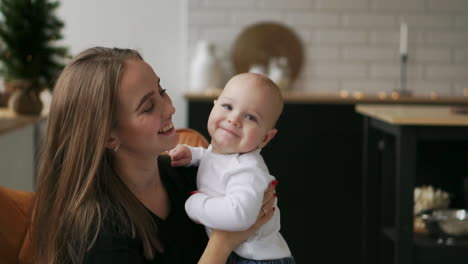 mother and baby slow motion. happy family. mom with her child smiling and laughing at home.