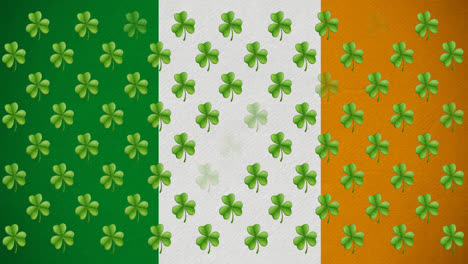 digital animation of multiple clover leaves floating against irish flag