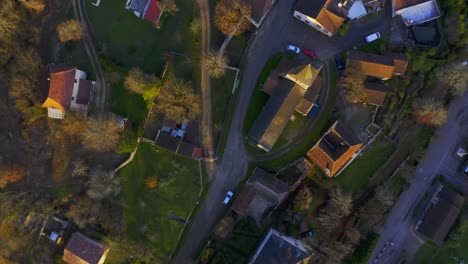 drone shot above a little french village during sunset