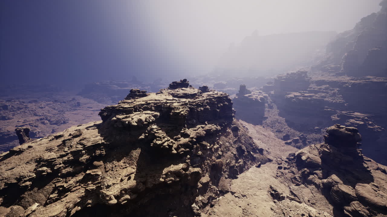 Breathtaking rock formations in a foggy canyon landscape at dawn