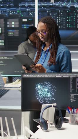 vertical video woman in server hub using ai visualization insights on tablet device