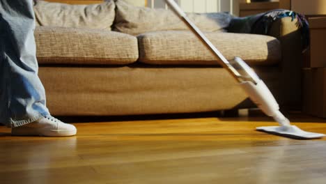 cleaning a wooden floor in a new house with a mop