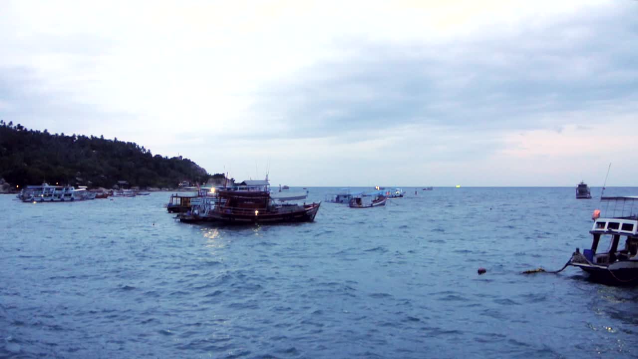 Island scuba diving boats flowing in the harbour along the coast line