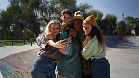 group of diverse teenagers taking a selfie at a vibrant skatepark