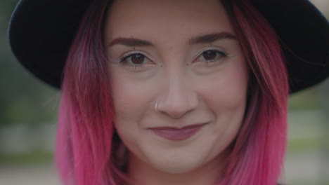 woman with pink hair and a hat