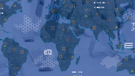 animation of circuit board pattern over map and geometric shapes against computer on desk in office