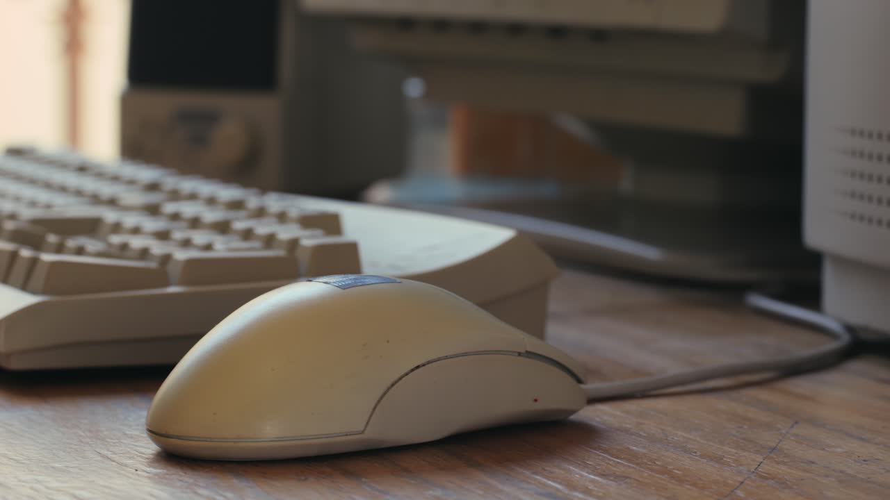 Man working and gaming on retro computer PC, IT engineer with vintage computer at home, using old fashion technology, close up of retro setup.
