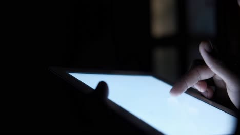 person using a tablet at night