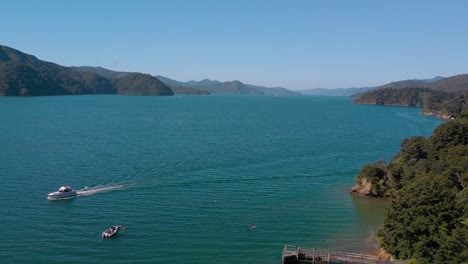 Aerial-view-of-boats-and-jetty-in-Queen-Charlotte-Sound,-Marlborough-Sounds,-South-Island,-New-Zealand