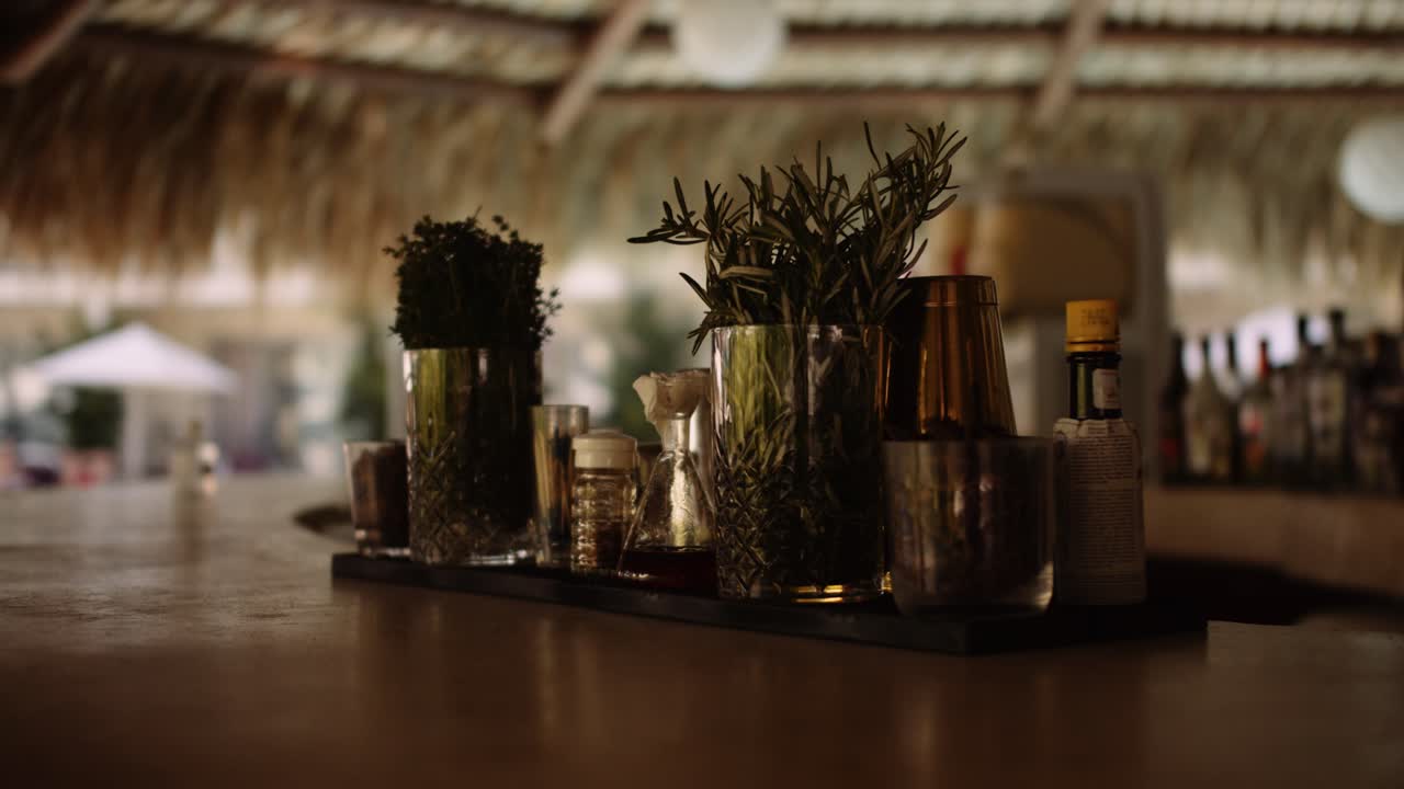 Drinks tray with various ingredients and mixers for cocktails at bar; parallax