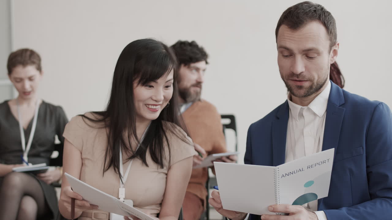 Colleagues Discussing Annual Report and Smiling