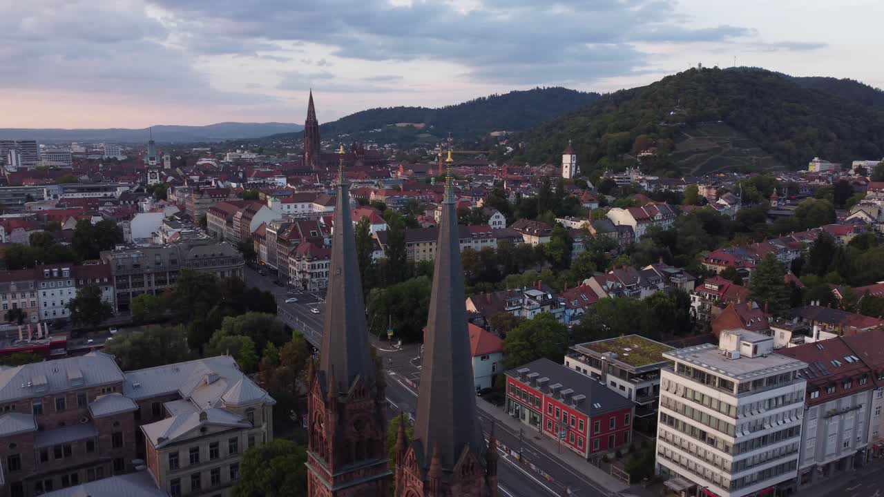 Aerial view of historical gothic old town of Freiburg im Breisgau during sunset with catholic church Johanneskirche in view , Germany