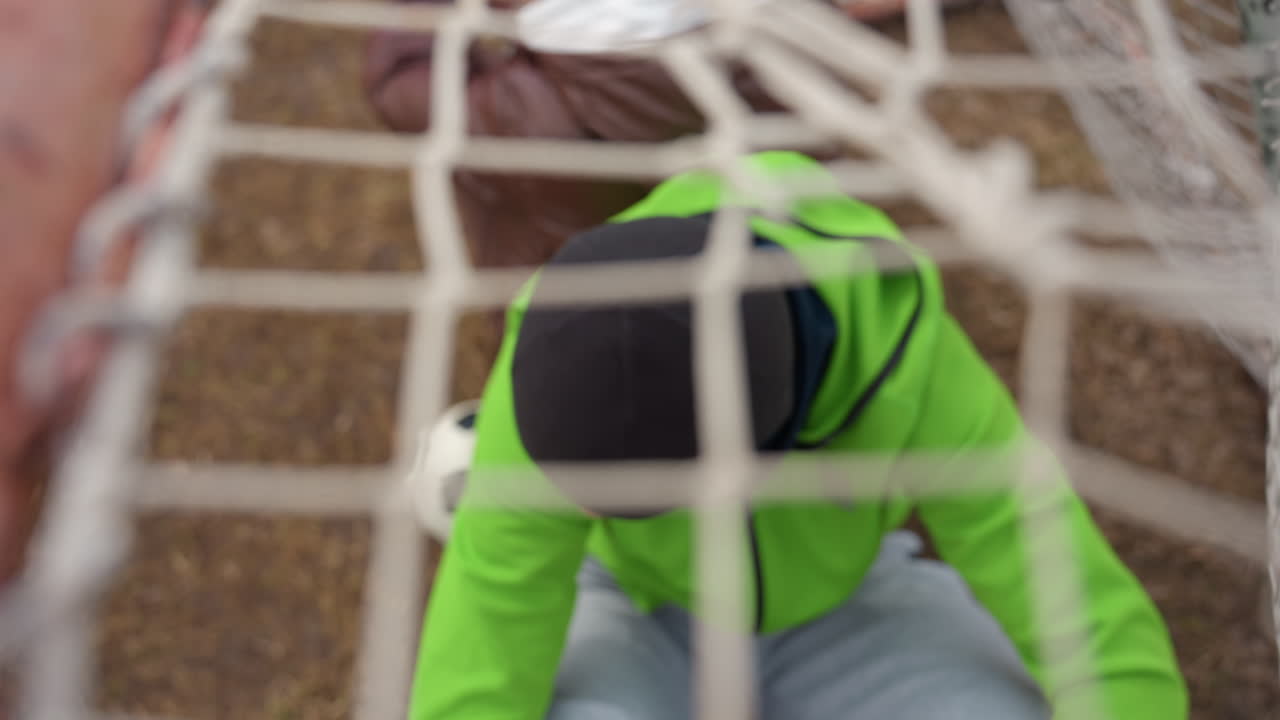 guarding stance active, goalkeeper maintaining alert defensive stance to defend goal effectively, protective athletic posture adopted by goalkeeper to shield goal from attacking players