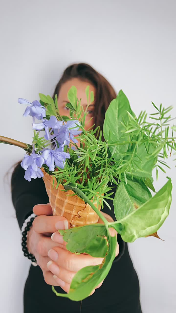 Woman Holding Flowers in an Ice Cream Cone