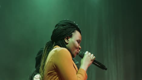 woman singing on stage