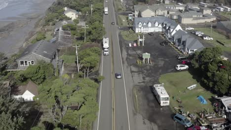 Aerial-over-highway-101-in-Oregon,-cars-and-trucks,-clear-sunny-afternoon