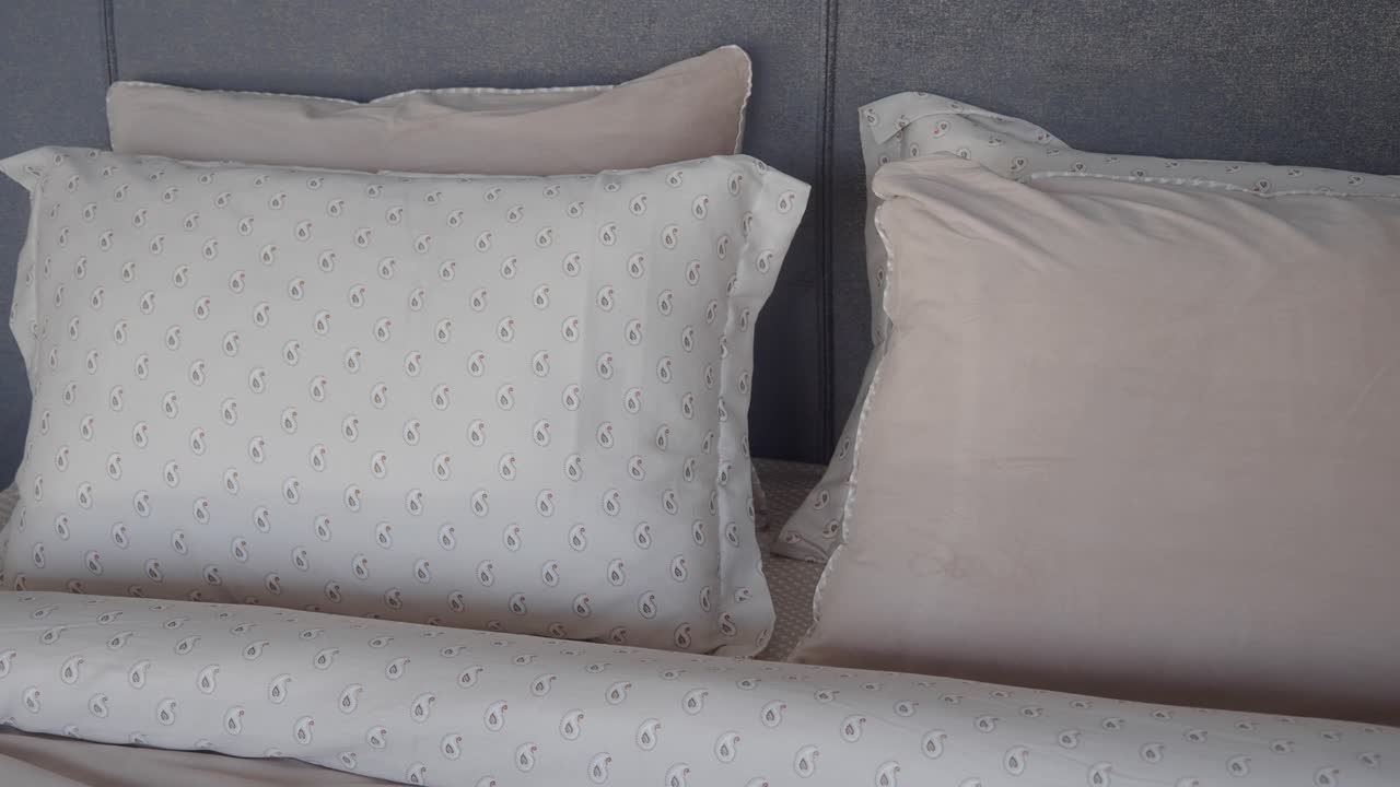 primer plano de una cama con almohadas y un edredón