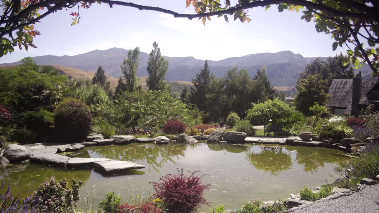 dolly in revealing the pond from the chapel