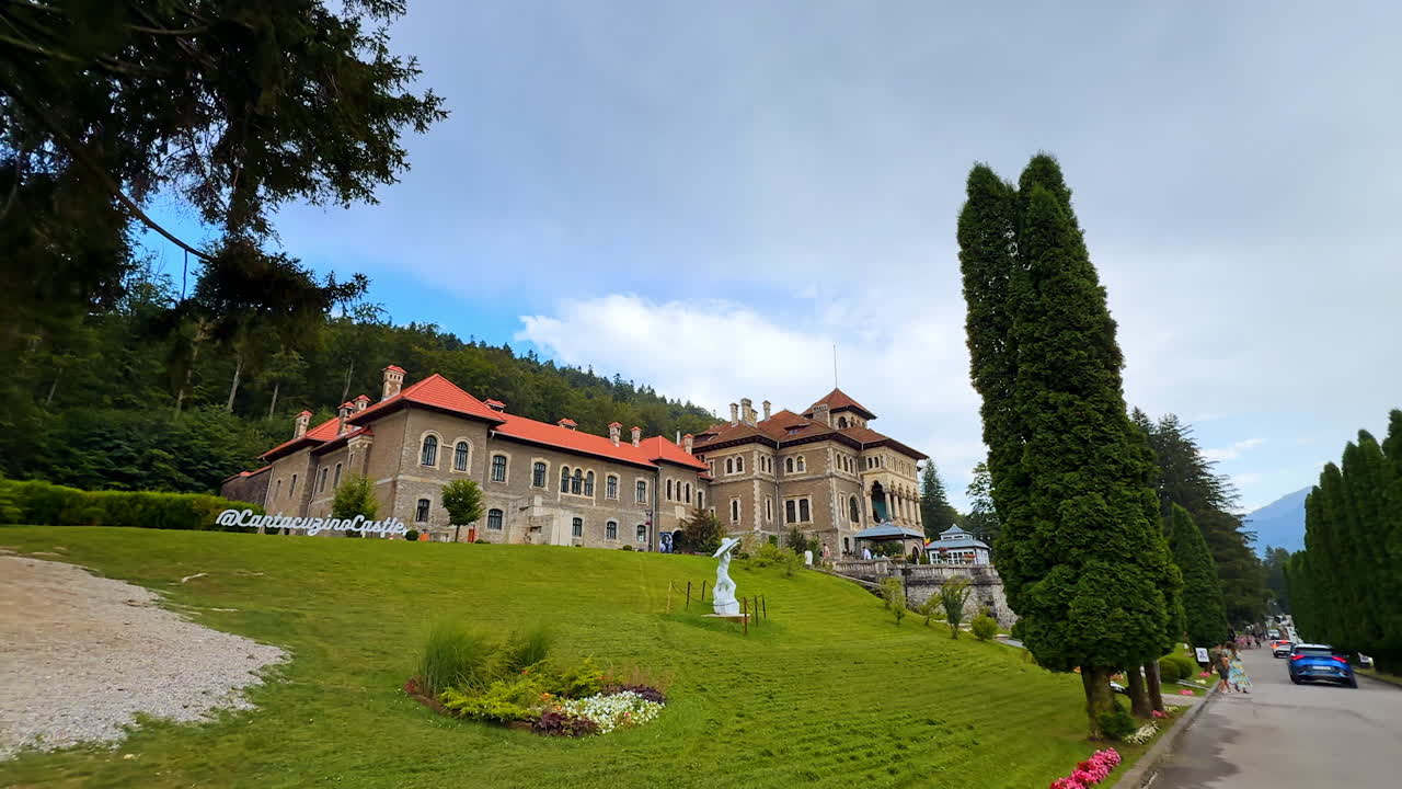 Busteni, Romania, 17 July 2025: Green hill with a beautiful Cantacuzino Castle. Gorgeous territory of Romanian landmark from low angle view