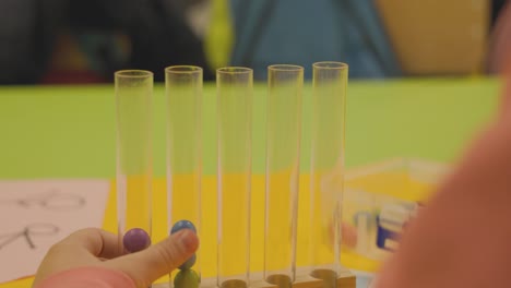 dropping a ball into a test tube