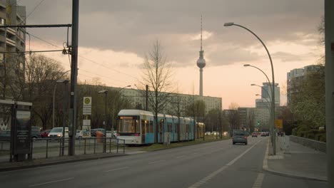 twilight scenery in city centre of berlin with modern tram and tv tower