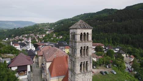 Scenic aerial orbit around ancient bell tower Saint Mary&#039;s church in Jajce