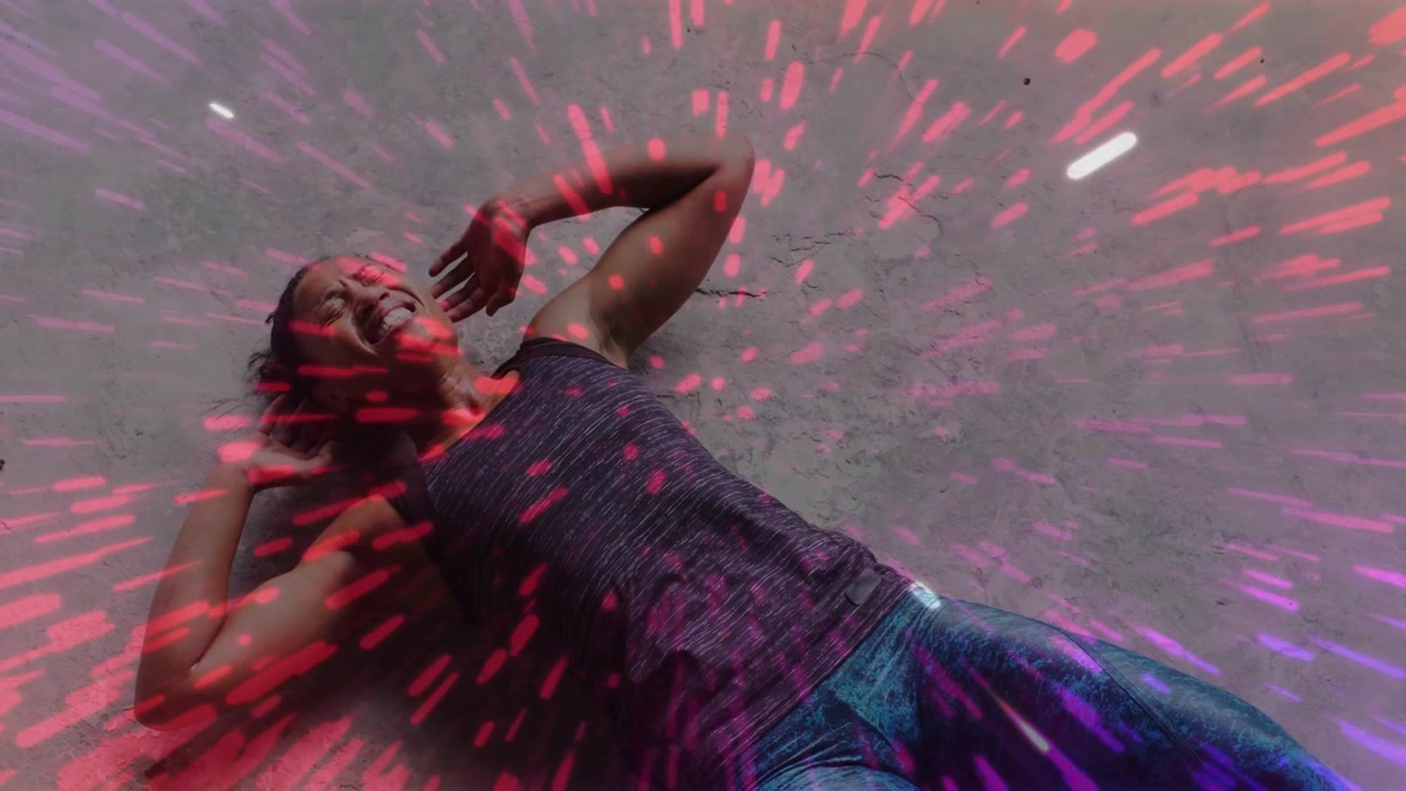 Overhead woman pressing relaxing on concrete gym while pink burst sweeping from torso easing pain