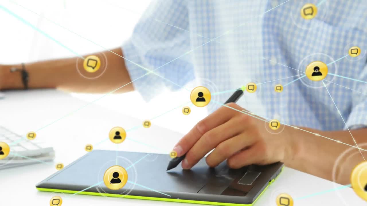 Animation of connected icons over caucasian male artist drawing on graphics tablet in office