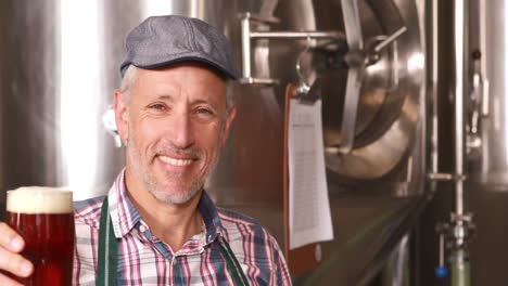 brewery worker holding a beer